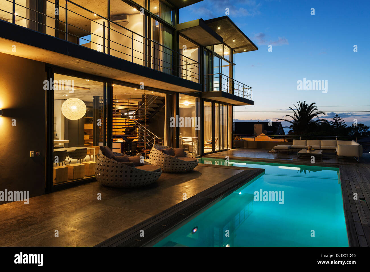 Luxury house with swimming pool illuminated at night Stock Photo