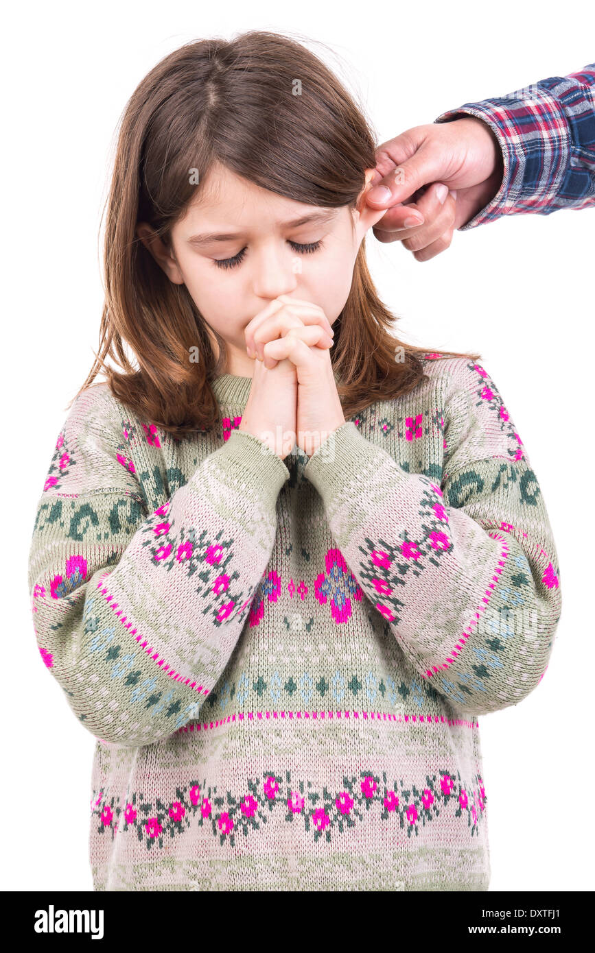 Young girl being punished with ear pulling Stock Photo Alamy