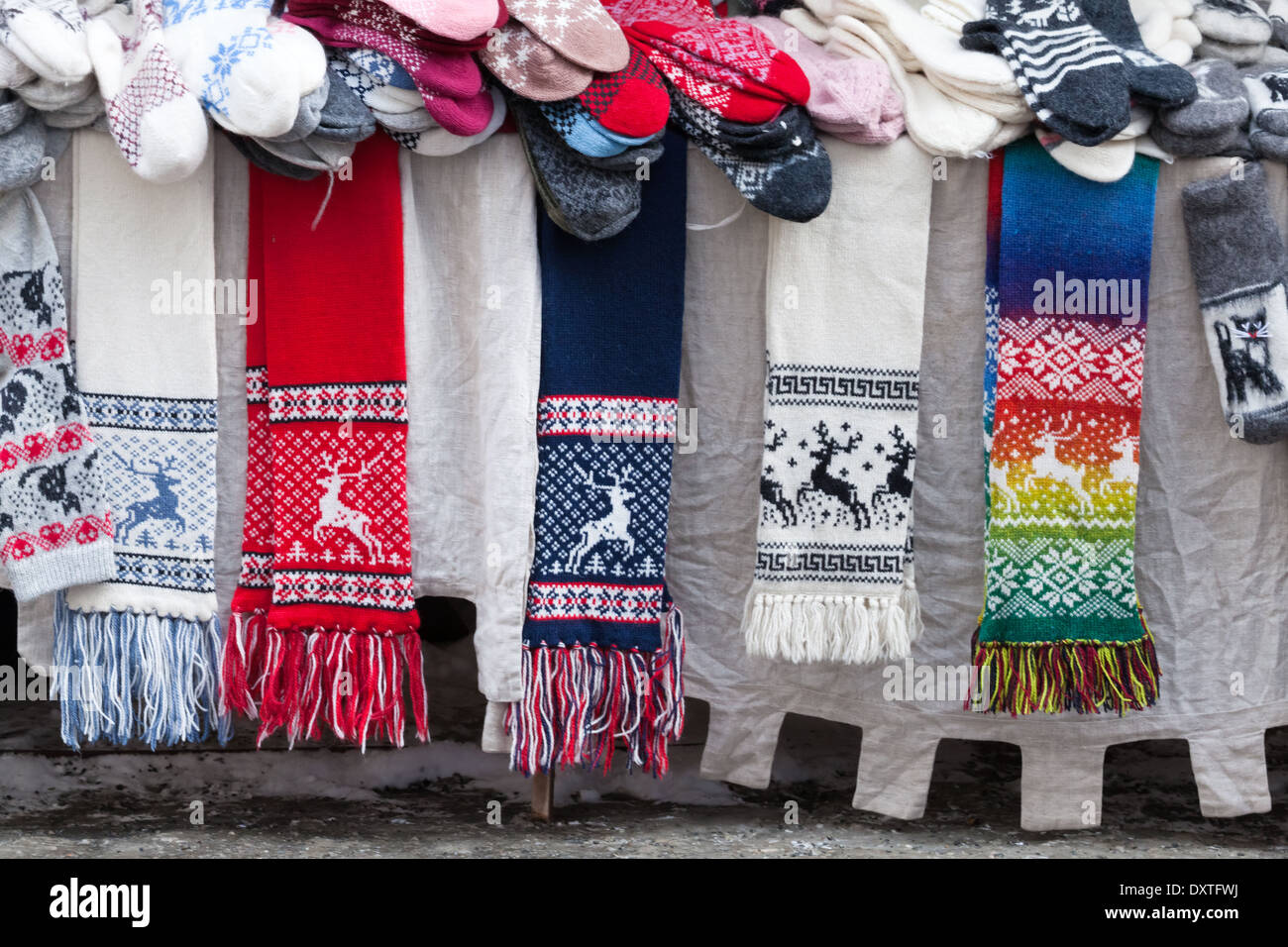 TALLINN, ESTONIA - MARCH 2013: Woolen scarves, socks and other souvenirs lie on the street counter on March 12, 2013 Stock Photo