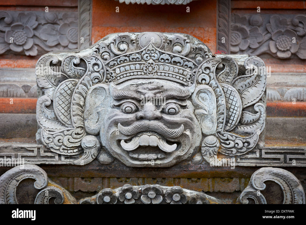 Portrait of a mythical character on the wall of the temple of the Indonesian Stock Photo