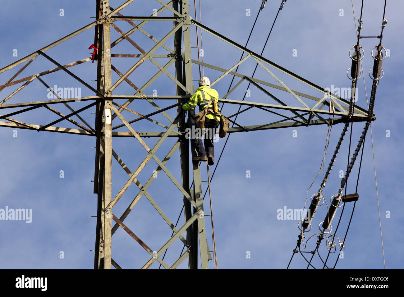 Electrical engineer climbing up an overhead electricity pylon to work Stock Photo 68151894 Alamy