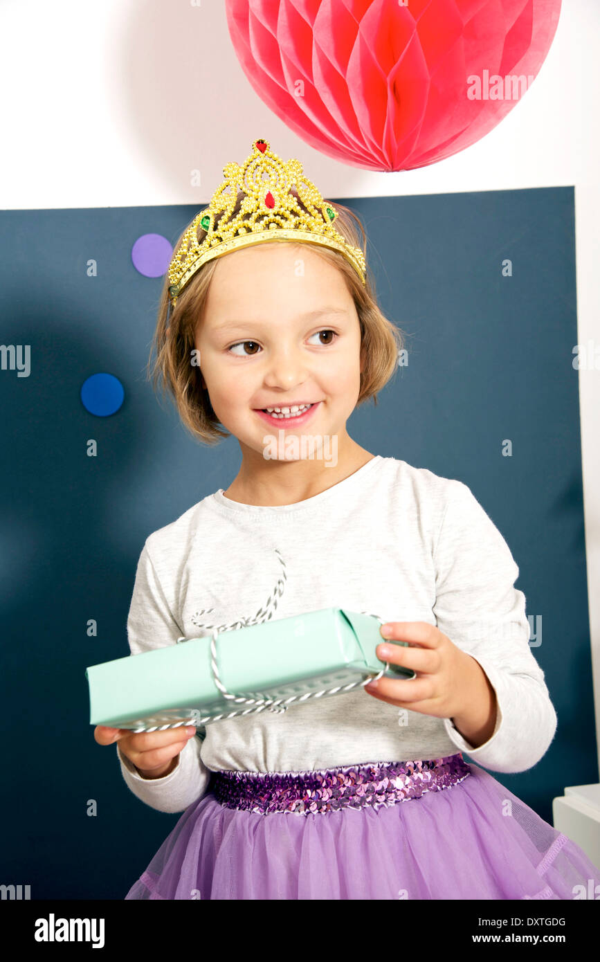 Birthday party, girl in costume holding present, Munich, Bavaria, Germany Stock Photo