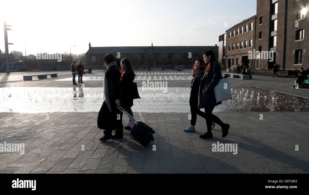 Students outside UAL University of the Arts Central St. Martins campus in Granary Square exterior building in Kings Cross London N1  KATHY DEWITT Stock Photo