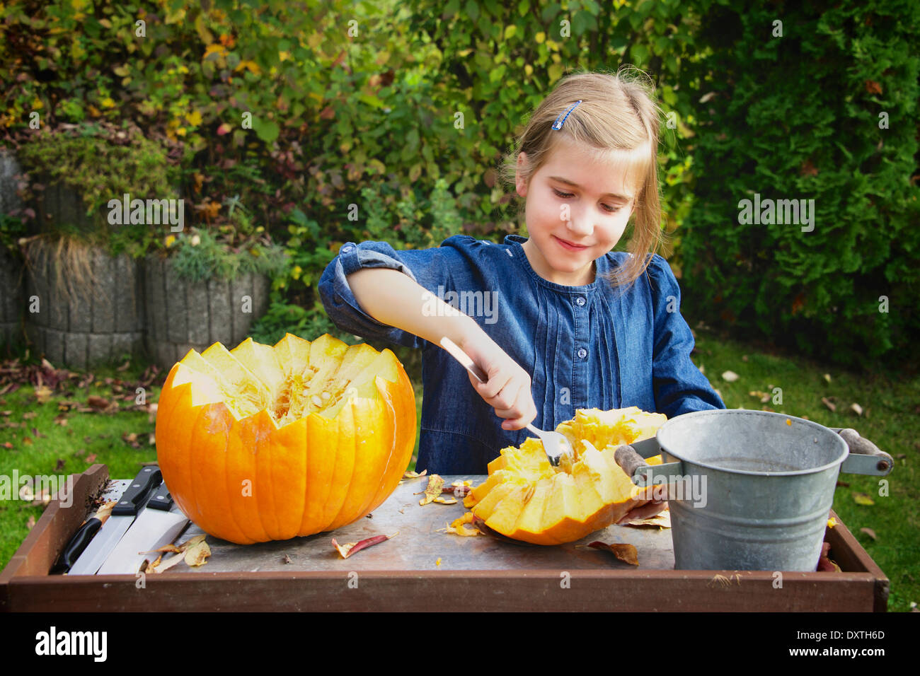 Girl carving Jack O'Lantern Stock Photo