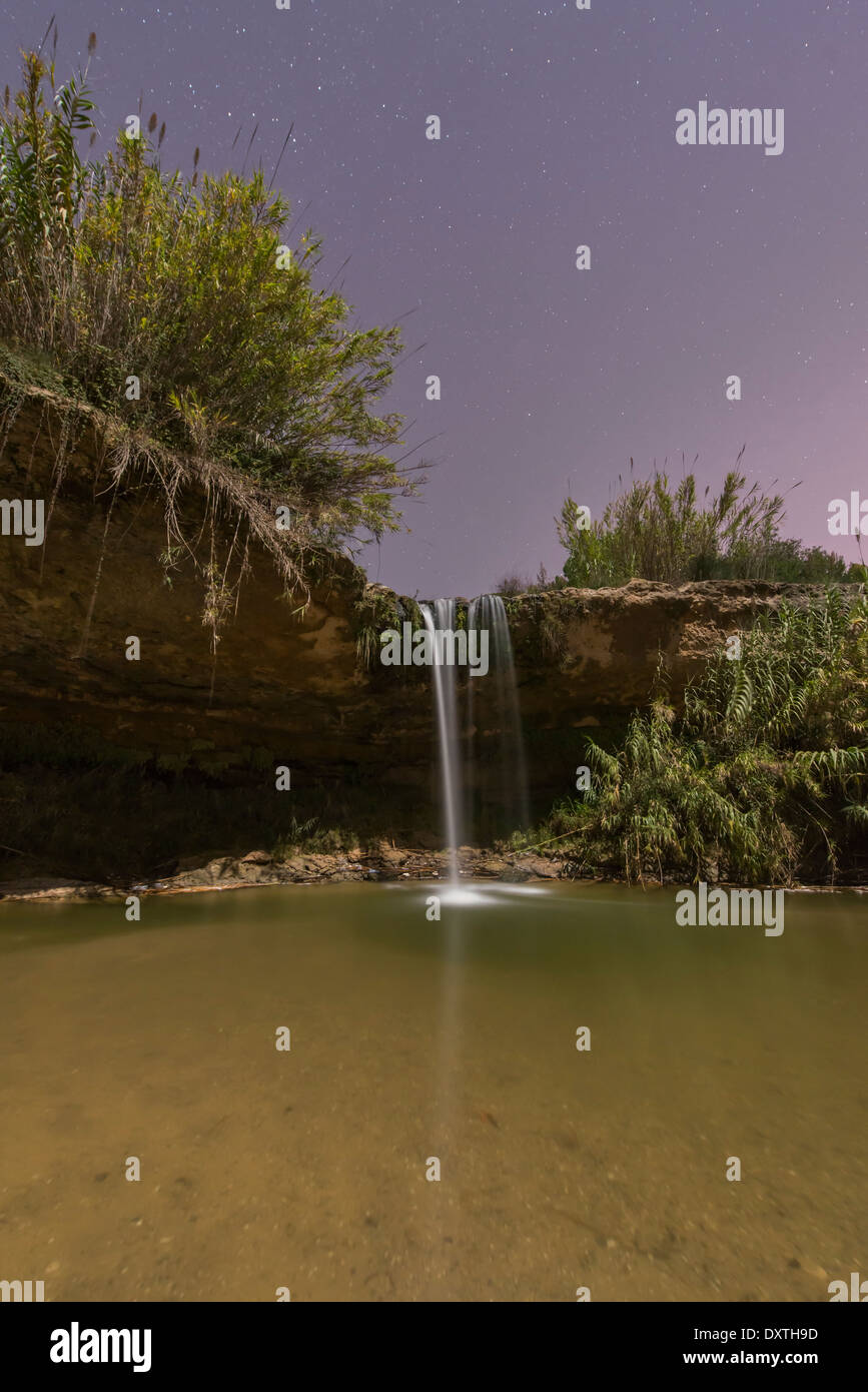 Creek and waterfall of Can Raimundet by night with stars and long exposure, Gelida, Spain Stock Photo