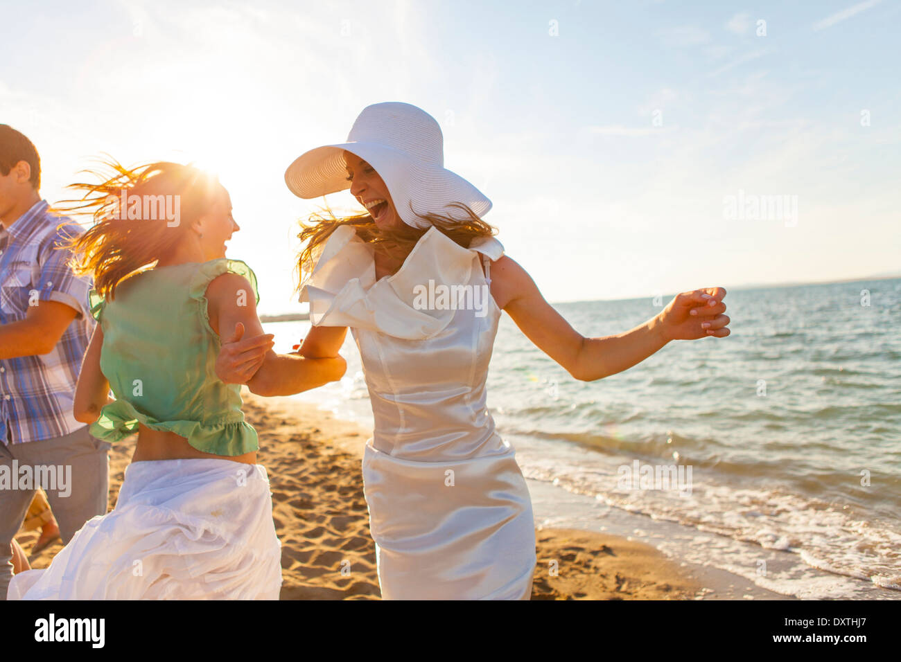Bride and girlfriend dancing on the beach, Dalmatia, Croatia Stock Photo