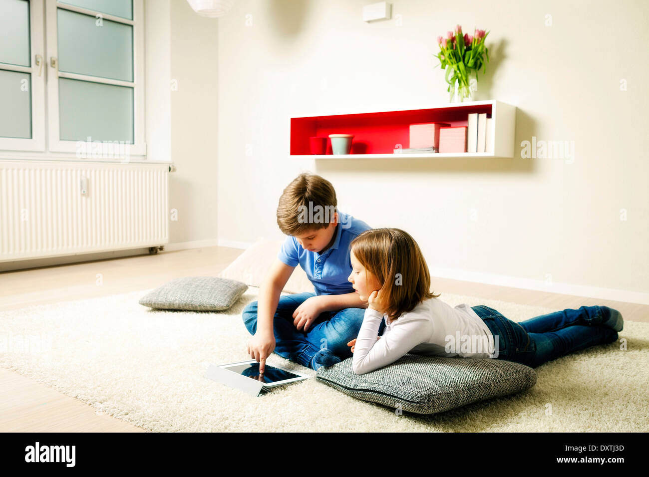 Children using tablet computer at home, Munich, Bavaria, Germany Stock Photo