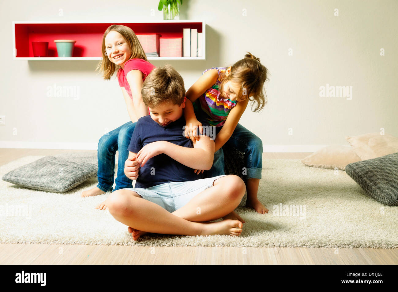 Children in living room fooling around, Munich, Bavaria, Germany Stock Photo