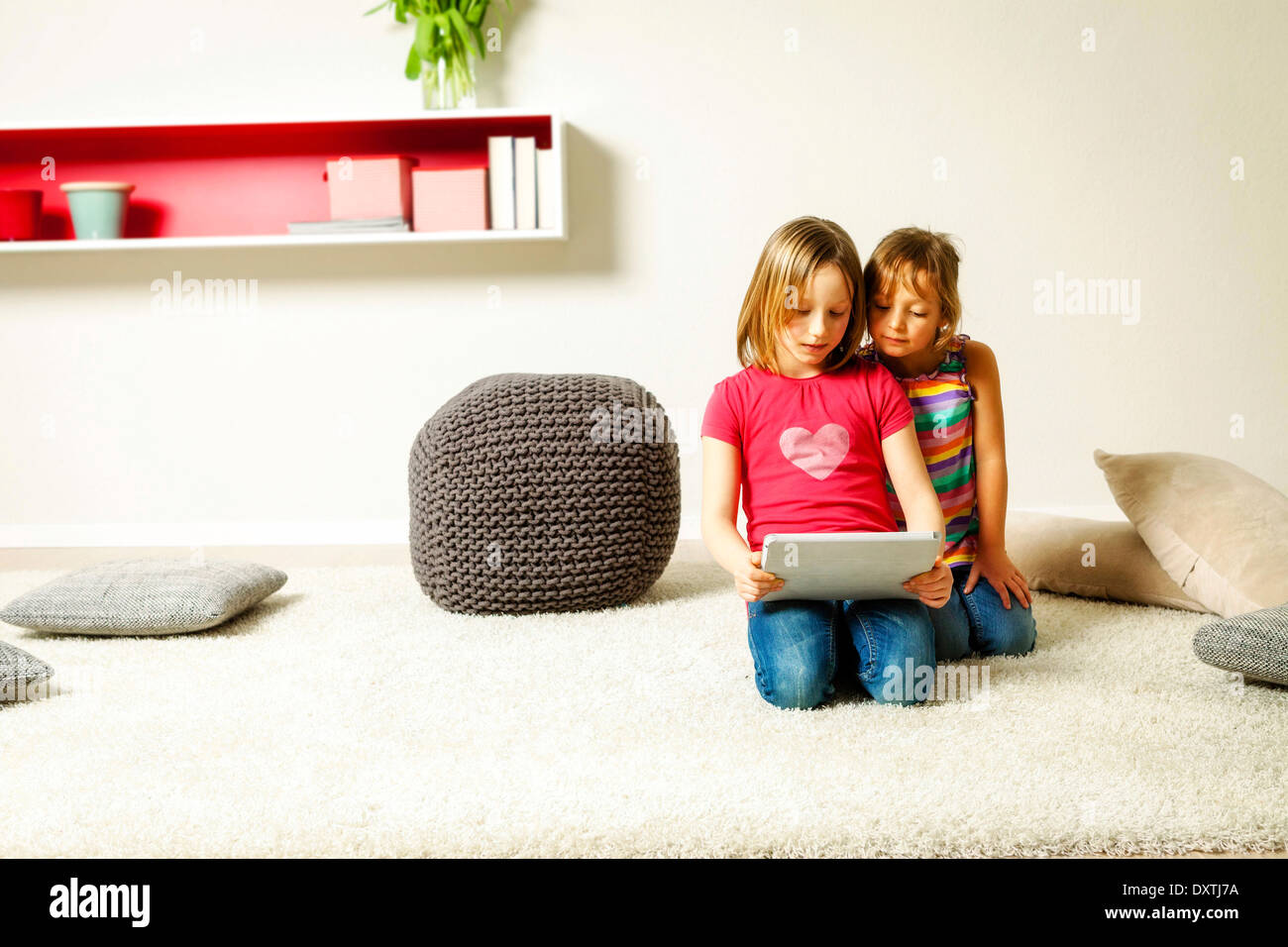 Children using tablet computer at home, Munich, Bavaria, Germany Stock Photo