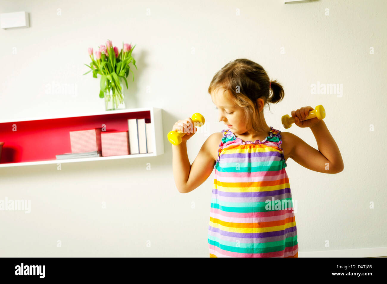 Girl exercising with dumbbells, Munich, Bavaria, Germany Stock Photo