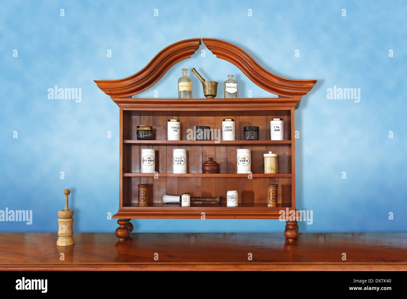 Various bottles and pots on a wooden shelf in old pharmacy Stock Photo