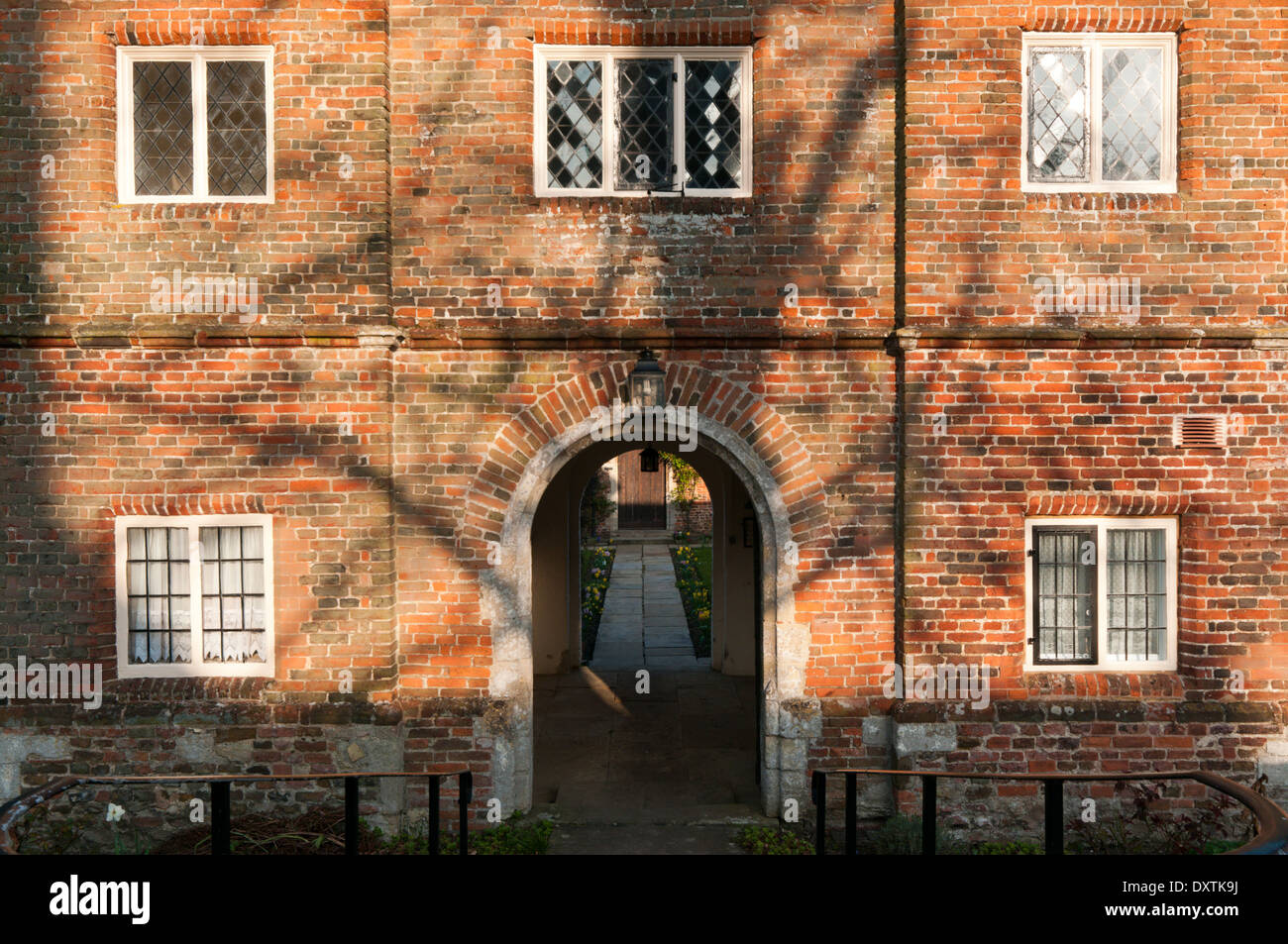 Evening sunlight on the brick front of the Trinity Hospital almshouses in Castle Rising, Norfolk. Stock Photo