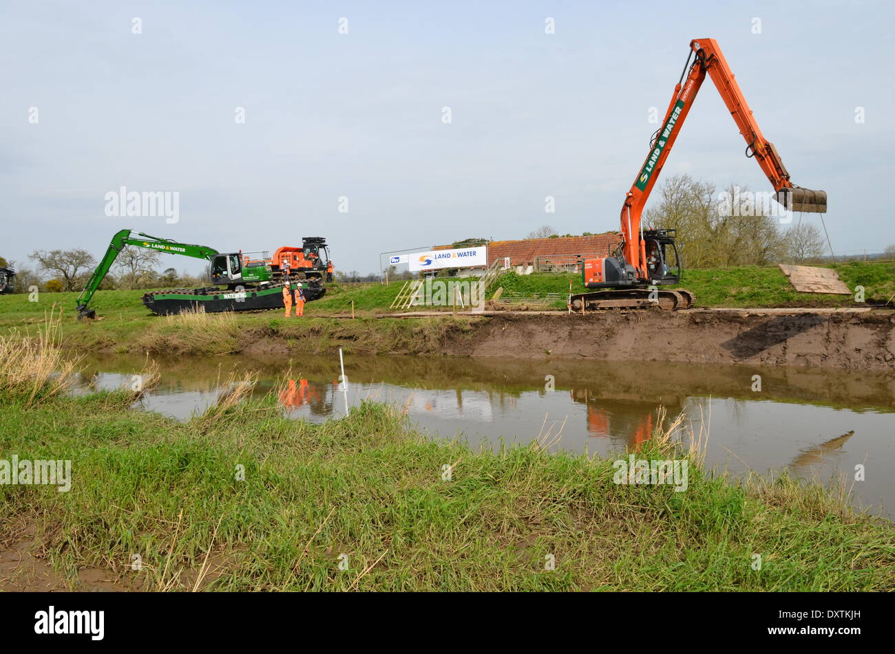 Near Burrowbridge, UK. 31st March, 2014. Work starts on Phase 1  of the dredging of the River Parrett - dredging on the riverside. The dredging comes in the wake of extreme flooding on the Somerset levels which some have blamed on a lack of dredging of the waterways.  Equipment being used is Hitachi ZX225usr with GPS dig system,also 13t Amphibious Excavator and a 7 ton tracked dumpers Credit:  Robert Timoney/Alamy Live News Stock Photo