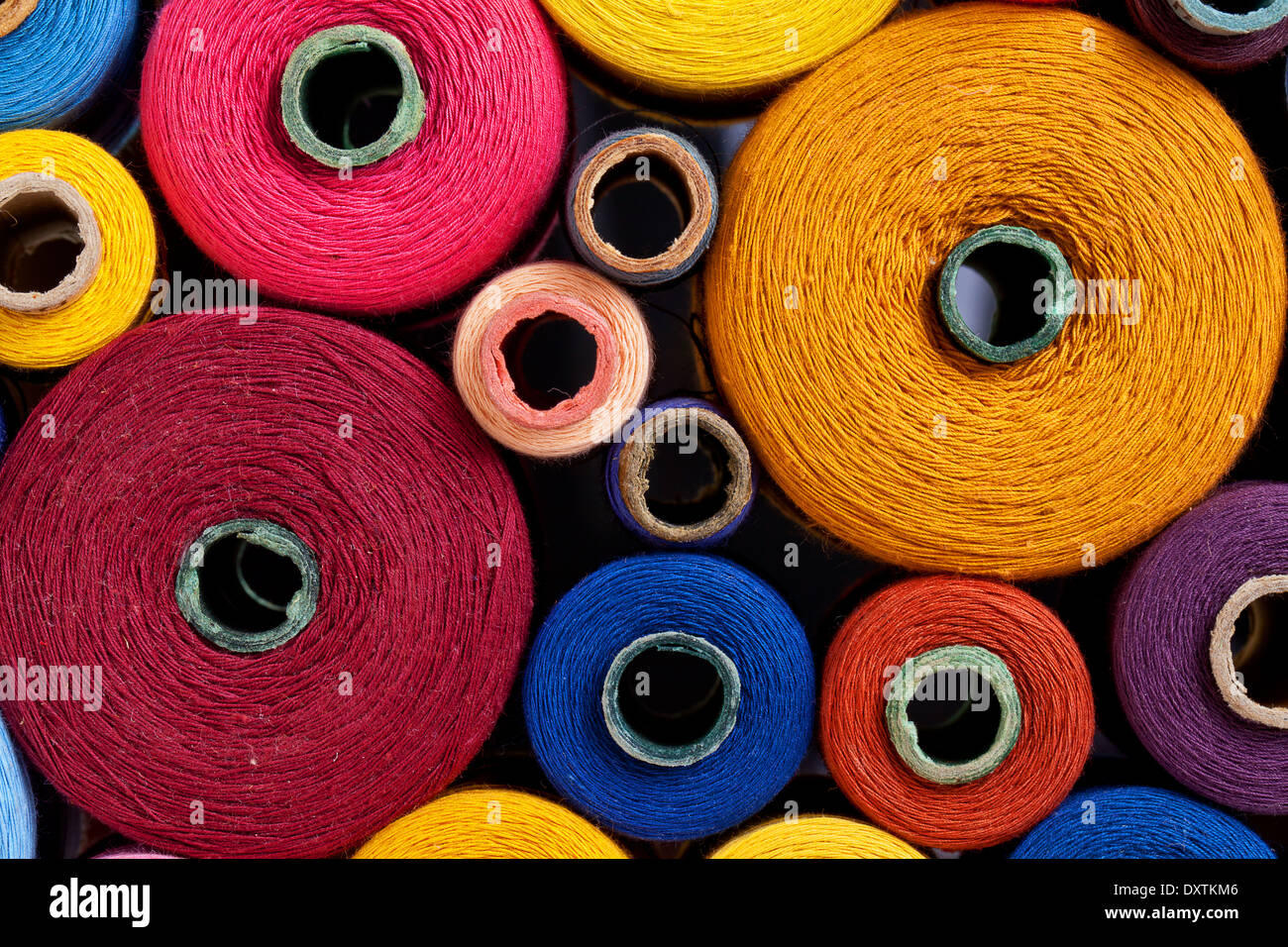 Multicolored Large Spools Of Thread In A Row Spools Of Colored