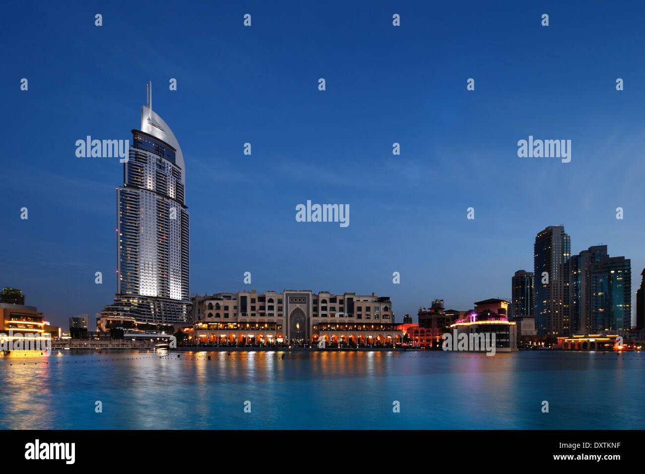 The Dubai Mall and The Address Hotel at Dusk as the Dubai Fountain sits still and acts as a perfect reflection pool Stock Photo