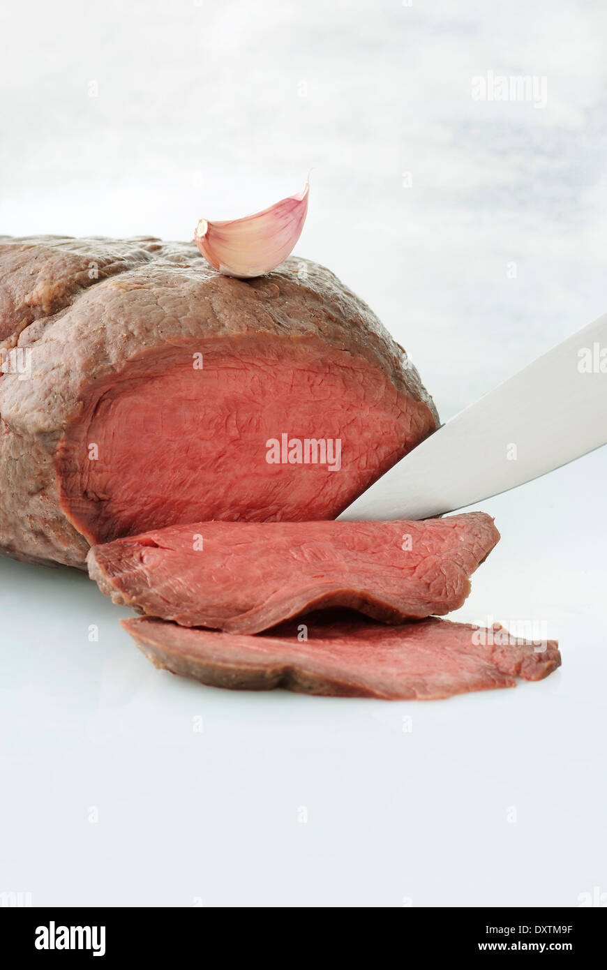 Carving a roast beef Stock Photo Alamy