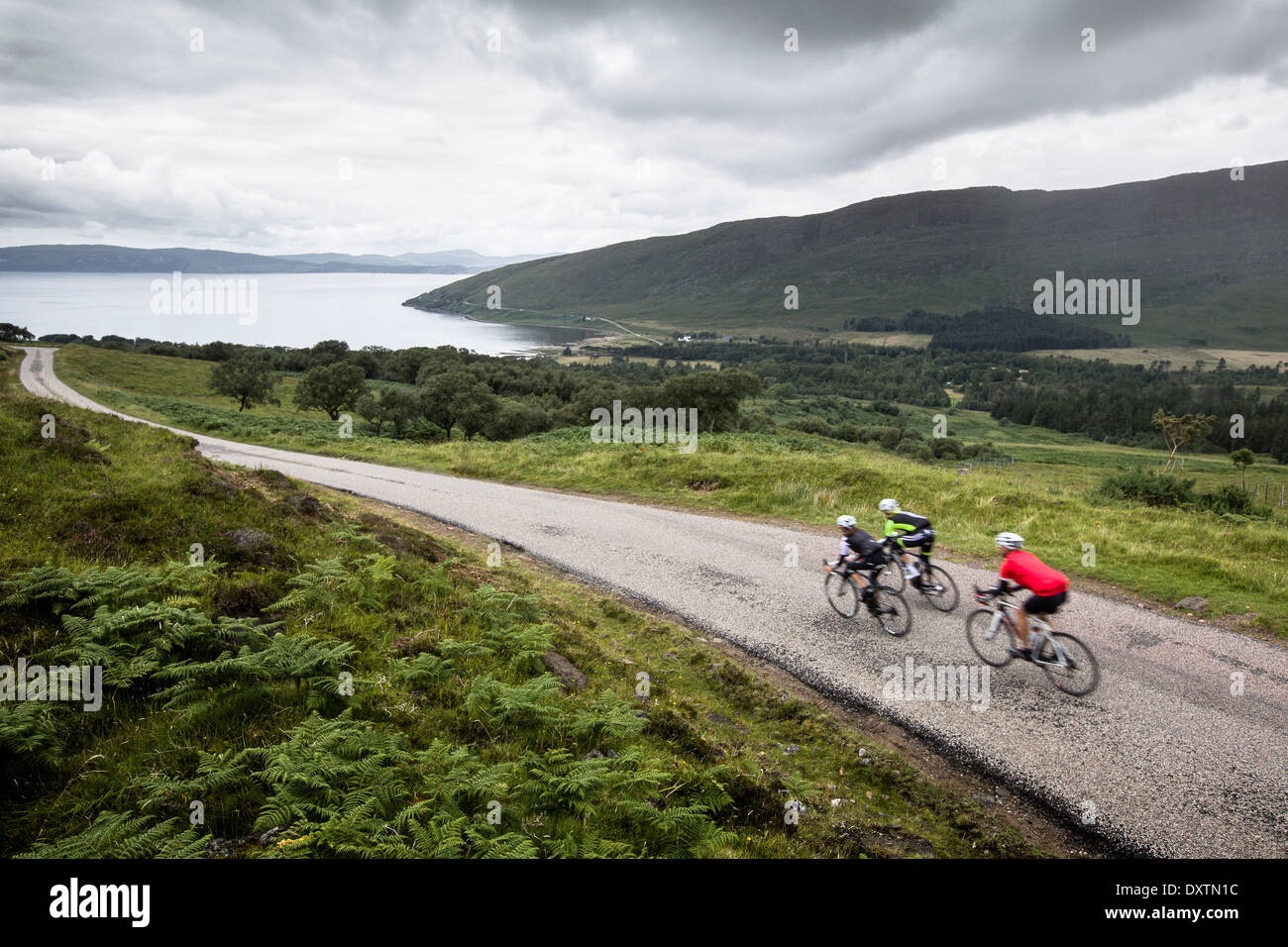 Three cyclists take on Britain's longest road climb in Lochcarron, Scotland Stock Photo