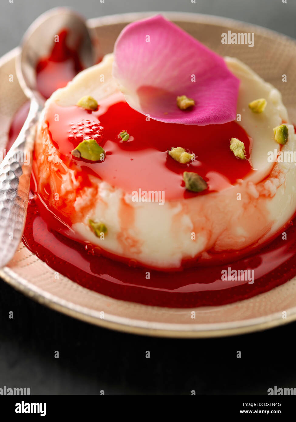 Lebanese Flan with summer fruit puree and pstachios Stock Photo