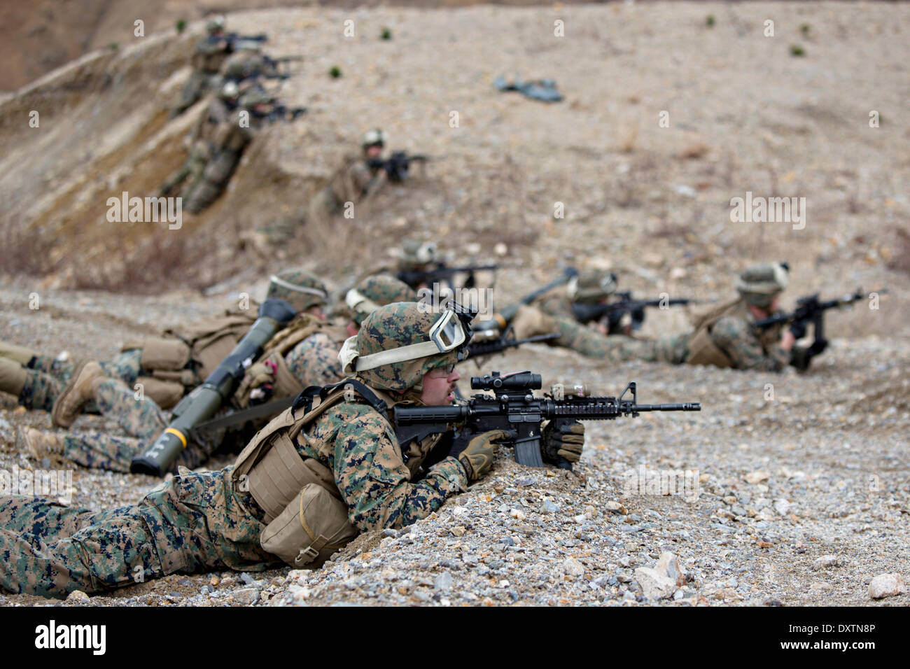 US Marines take cover during live fire exercises as part of joint training exercise Ssang Yong March 26, 2014 in Suesongri, South Korea. Stock Photo