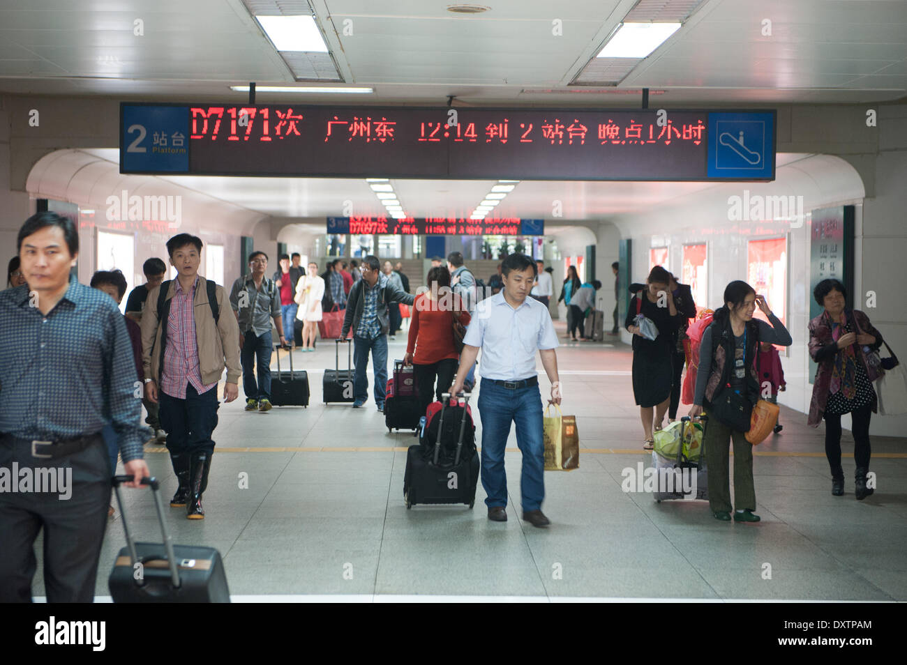 Shenzhen, China's Guangdong Province. 31st Mar, 2014. Passengers walk out of the rail station of Shenzhen, south China's Guangdong Province, March 31, 2014. Heavy rain also grounded flights and stranded passengers at major airports of Guangdong since Sunday. As of 6:30 p.m., a total of 113 flights had been canceled at the Shenzhen Bao'an International Airport on Monday, with 43 outbound flights delayed for at least two hours, according to sources with the airport. © Mao Siqian/Xinhua/Alamy Live News Stock Photo