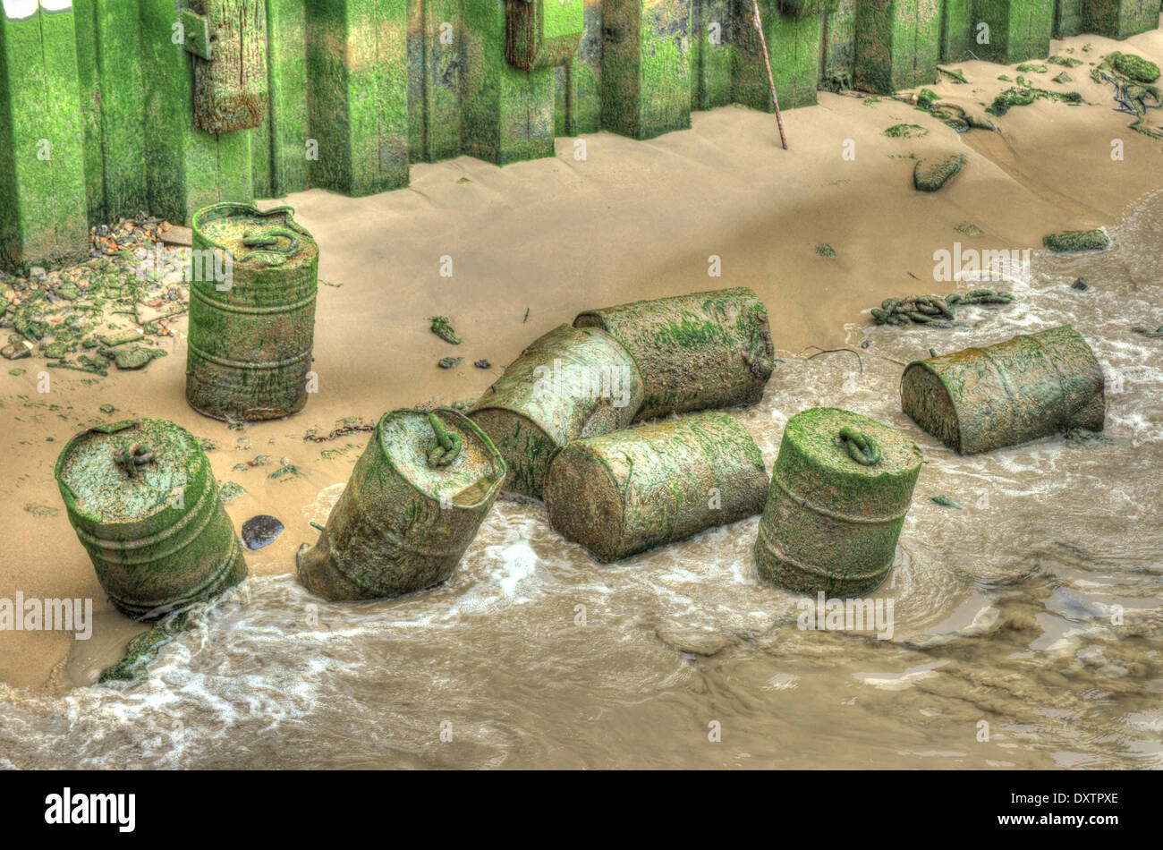 steel barrels abandoned on Thames shoreline Stock Photo