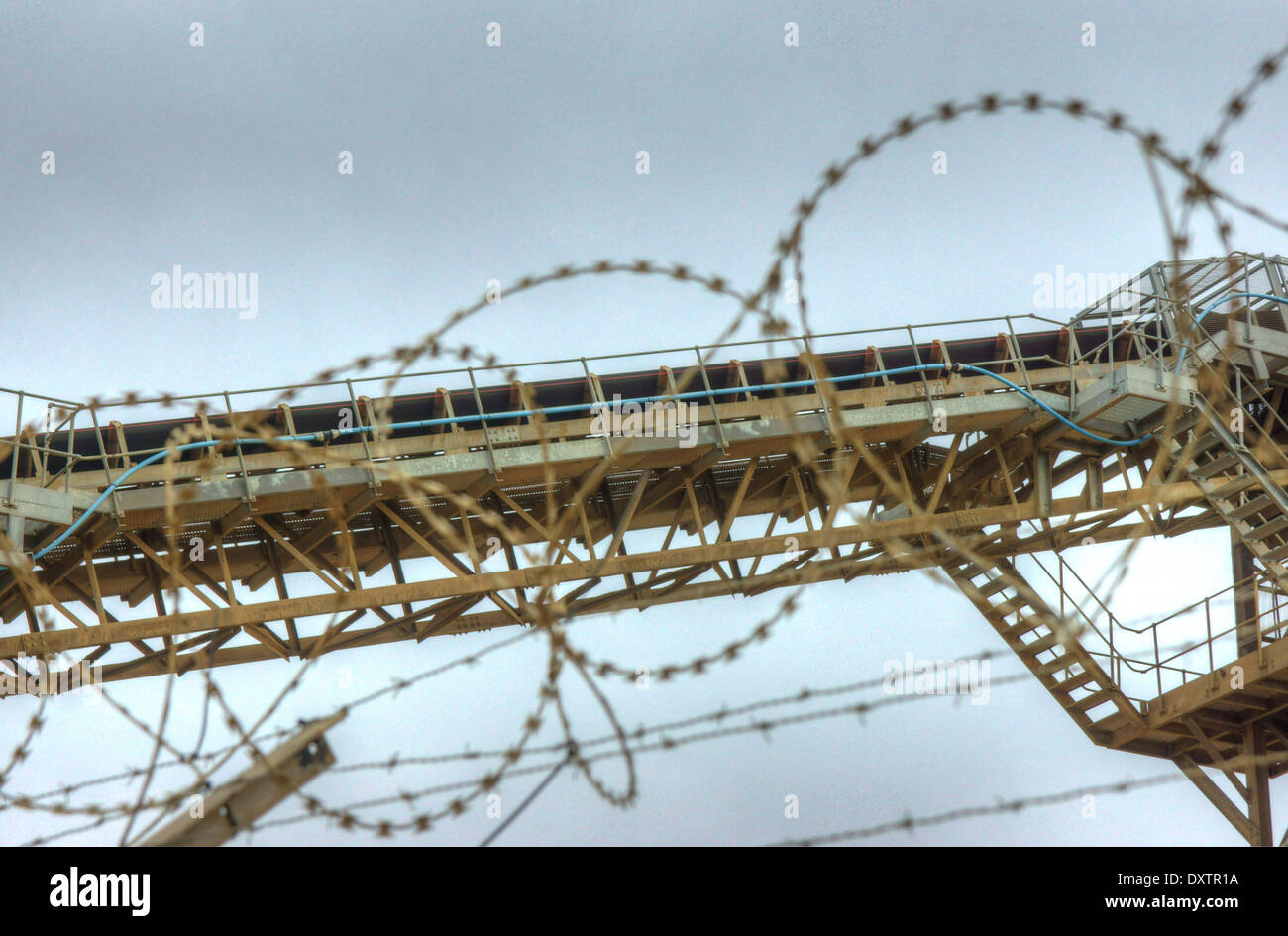 industrial conveyor belt  industrial machinery,  barbed wire Stock Photo