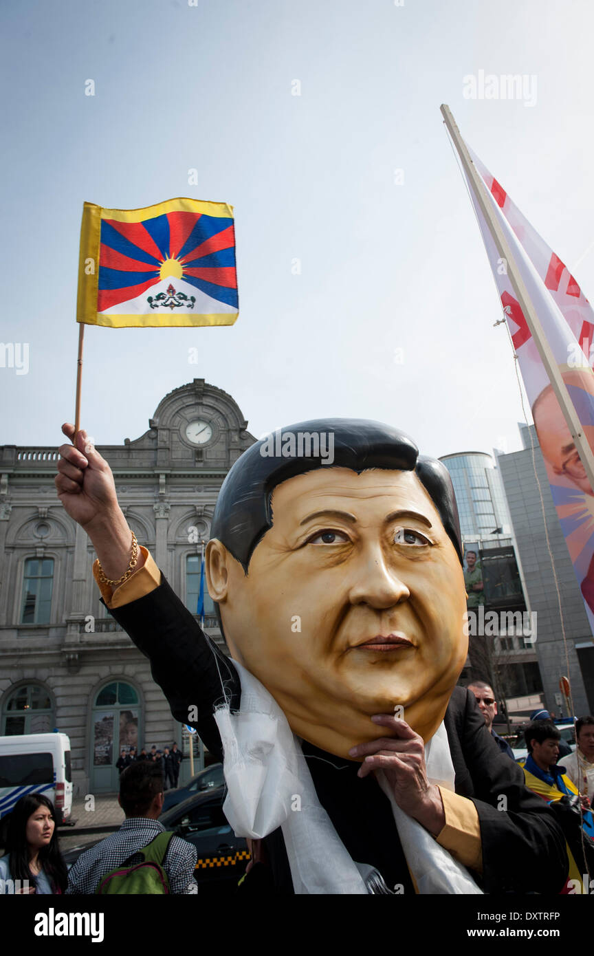 Brussels, Belgium. 31st Mar, 2014. Demonstrator wears mask of the Chinese president during a protest demanding for human rights in the People's Republic of China (PRC) in Brussels, Belgium. Chinese President Xi Jinping and his wife are on a three-day visit to Belgium. European citizens, human rights activists, members of the Tibetan and Uyghur communities, Chinese activists, and Falun Gong practitioners will be demonstrating on the streets of Brussels to voice their concerns about the human rights situation in China, Xinjiang and Tibet. Credit:  Wiktor Dabkowski/ZUMAPRESS.com/Alamy Live News Stock Photo