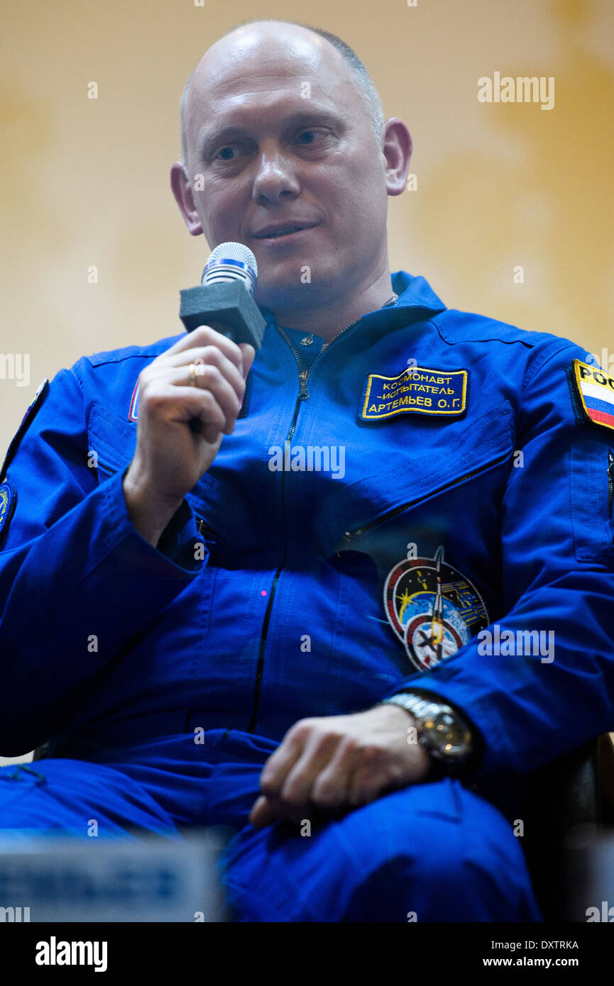 Expedition 40 flight engineer Oleg Artemyev rests outside the Soyuz ...