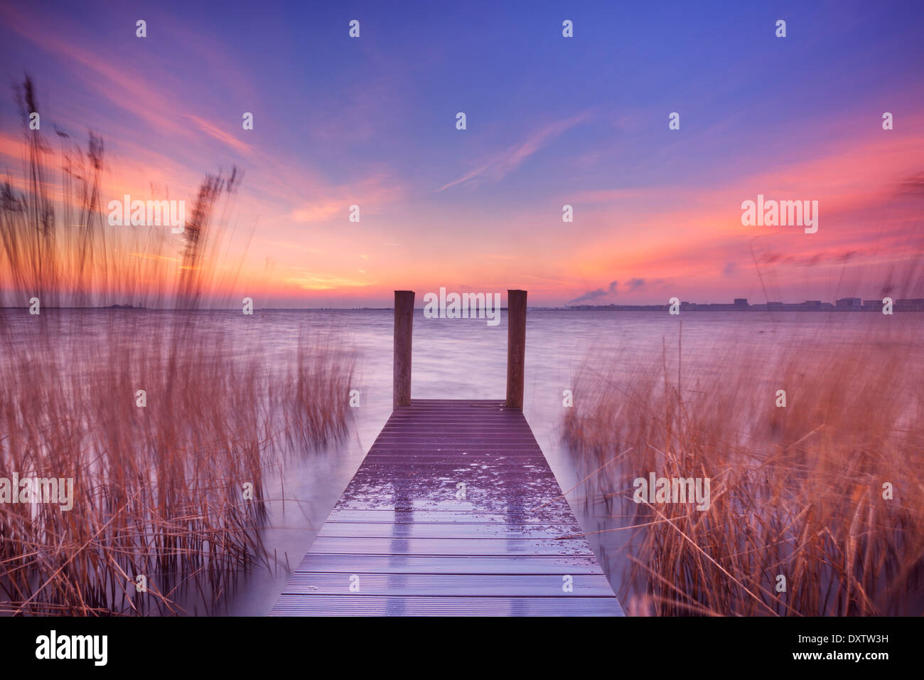 A small jetty on a lake at dawn Stock Photo