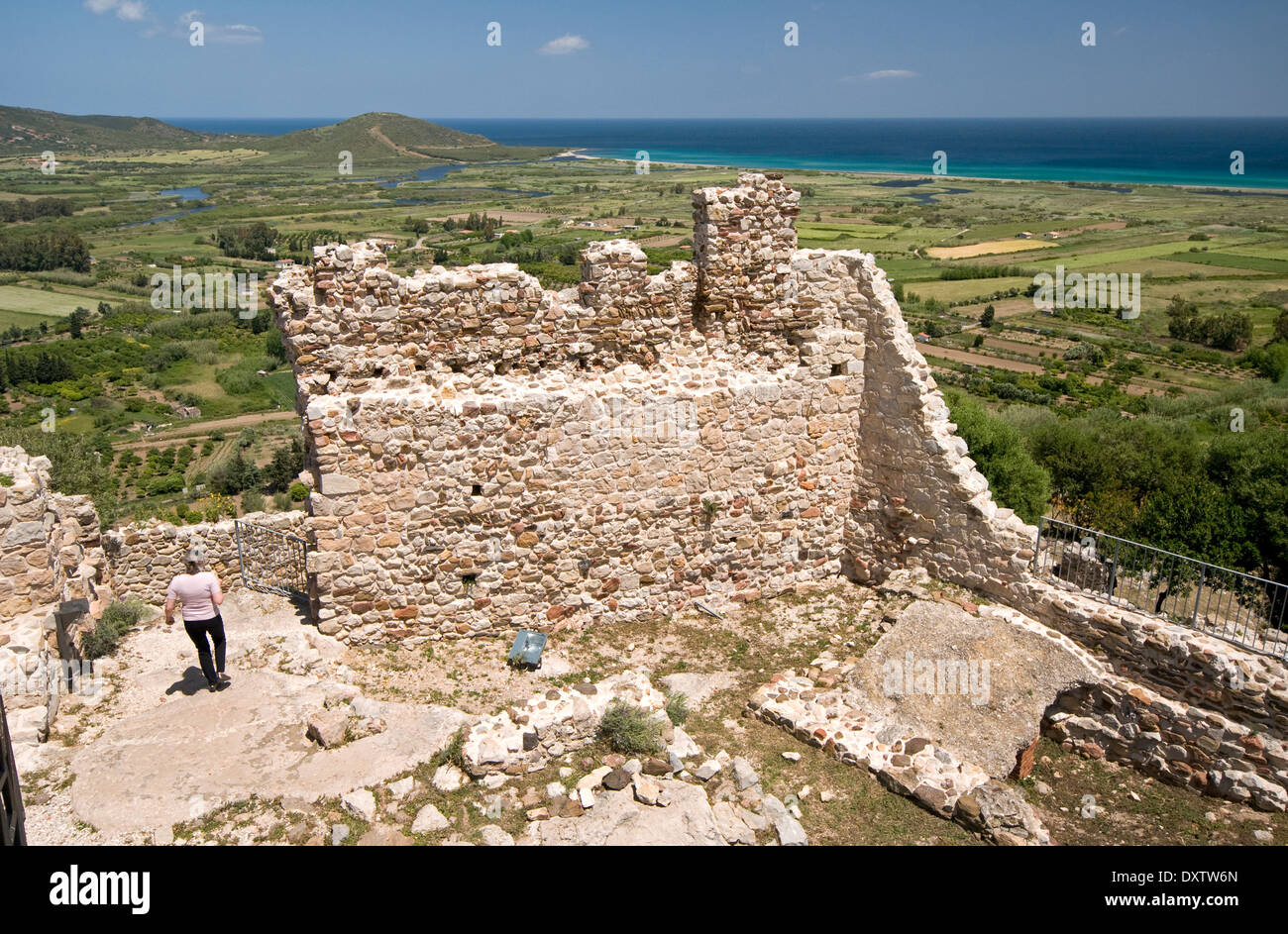 Tourist visiting the ruins of the old Fava castle, above Posada town near Siniscola, Sardinia, Italy Stock Photo