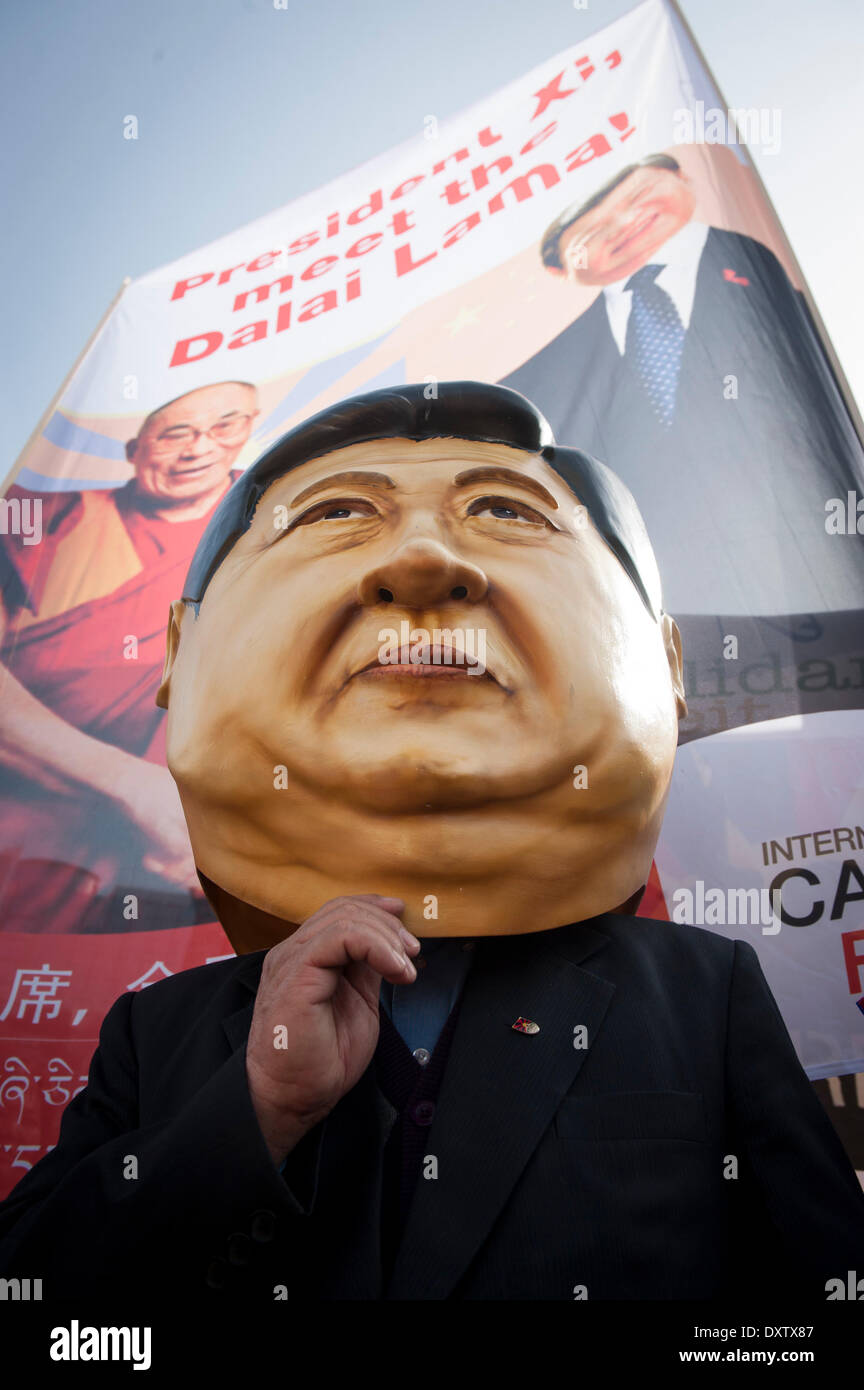 Brussels, Bxl, Belgium. 31st Mar, 2014. Demonstrator wear mask of Chinese president during a protest demanding for human rights in the People's Republic of China (PRC) in Brussels, Belgium on 31.03.2014 Chinese President Xi Jinping and his wife are on a three-day visit to Belgium. European citizens, human rights activists, members of the Tibetan and Uyghur communities, Chinese activists, and Falun Gong practitioners will be demonstrating on the streets of Brussels to voice their concerns about the human rights situation in China, Xinjiang and Tibet. by Wiktor Dabkowski (Credit Image: © Wikto Stock Photo