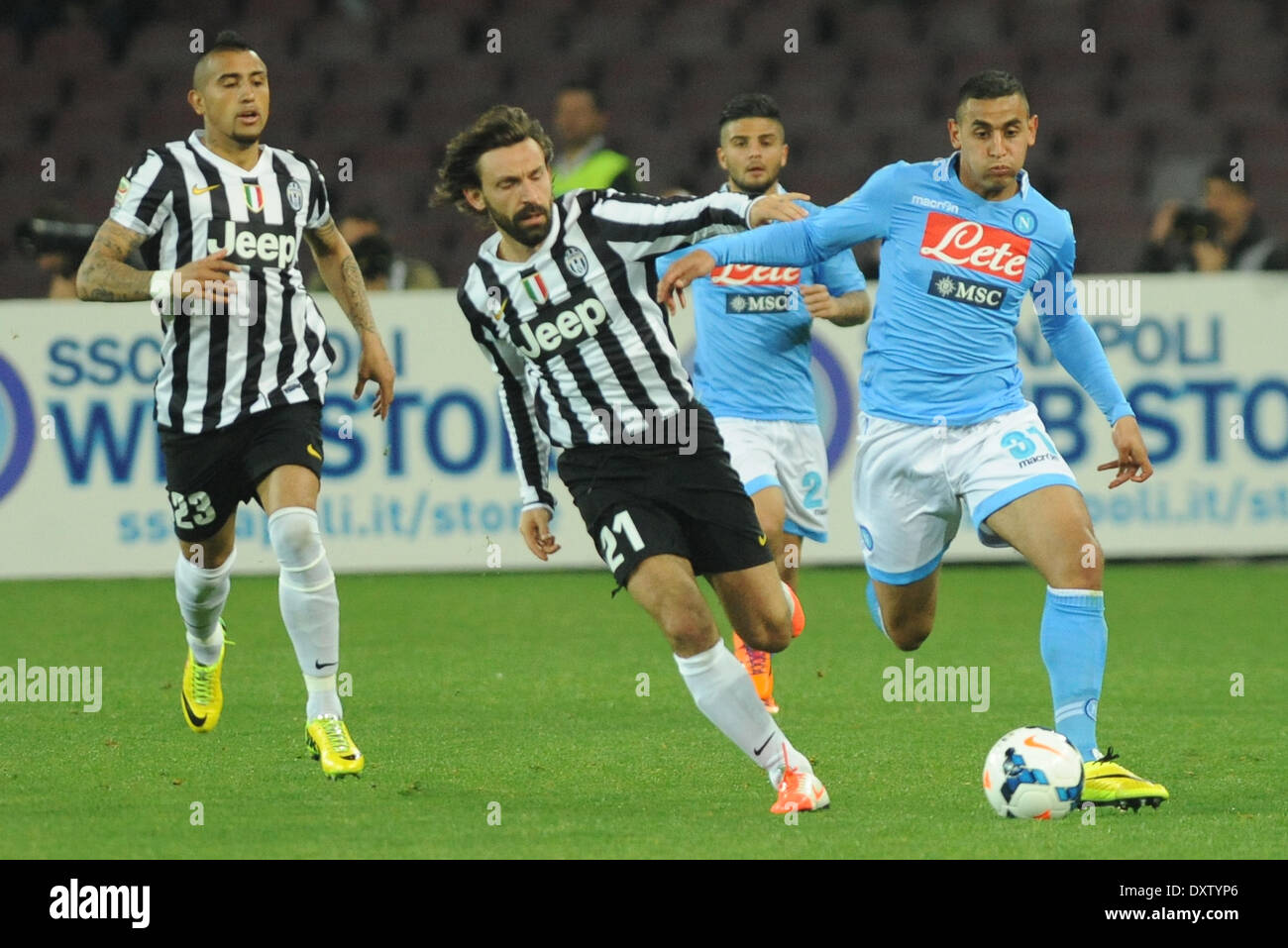 Naples, Italy. 30th Mar, 2014. Andrea Pirlo competes for the ball with Faouzi Ghoulam during Italian Serie A match between SSC Napoli and Juventus Football/Soccer at Stadio San Paolo on March 30, 2014 in Naples, Italy. © Franco Romano/NurPhoto/ZUMAPRESS.com/Alamy Live News Stock Photo
