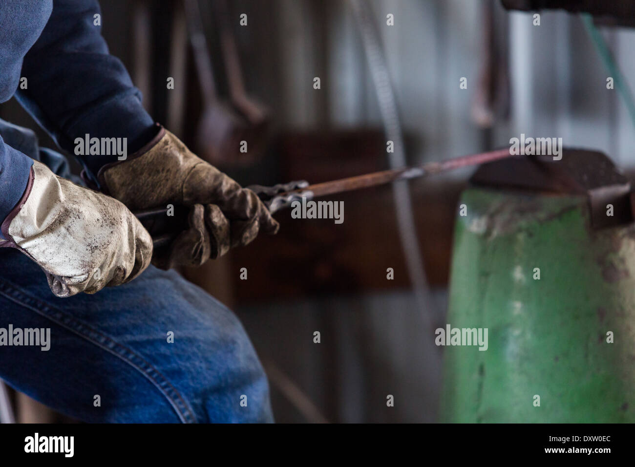 A blacksmith forging hot iron on the anvil Stock Photo - Alamy
