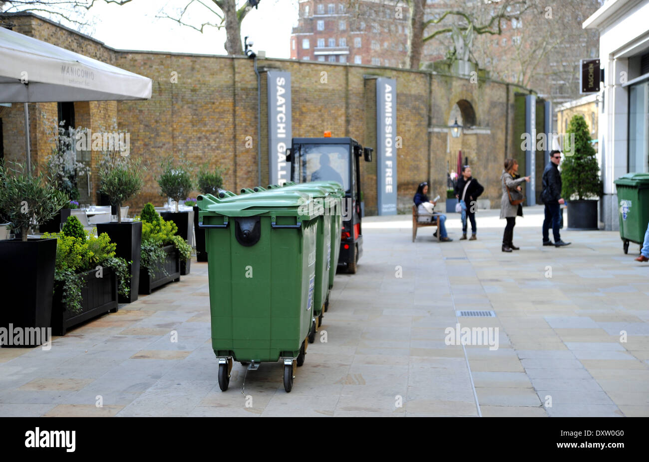 Train of Rubbish bins being pulled along by a cart just off Sloane Square London Stock Photo