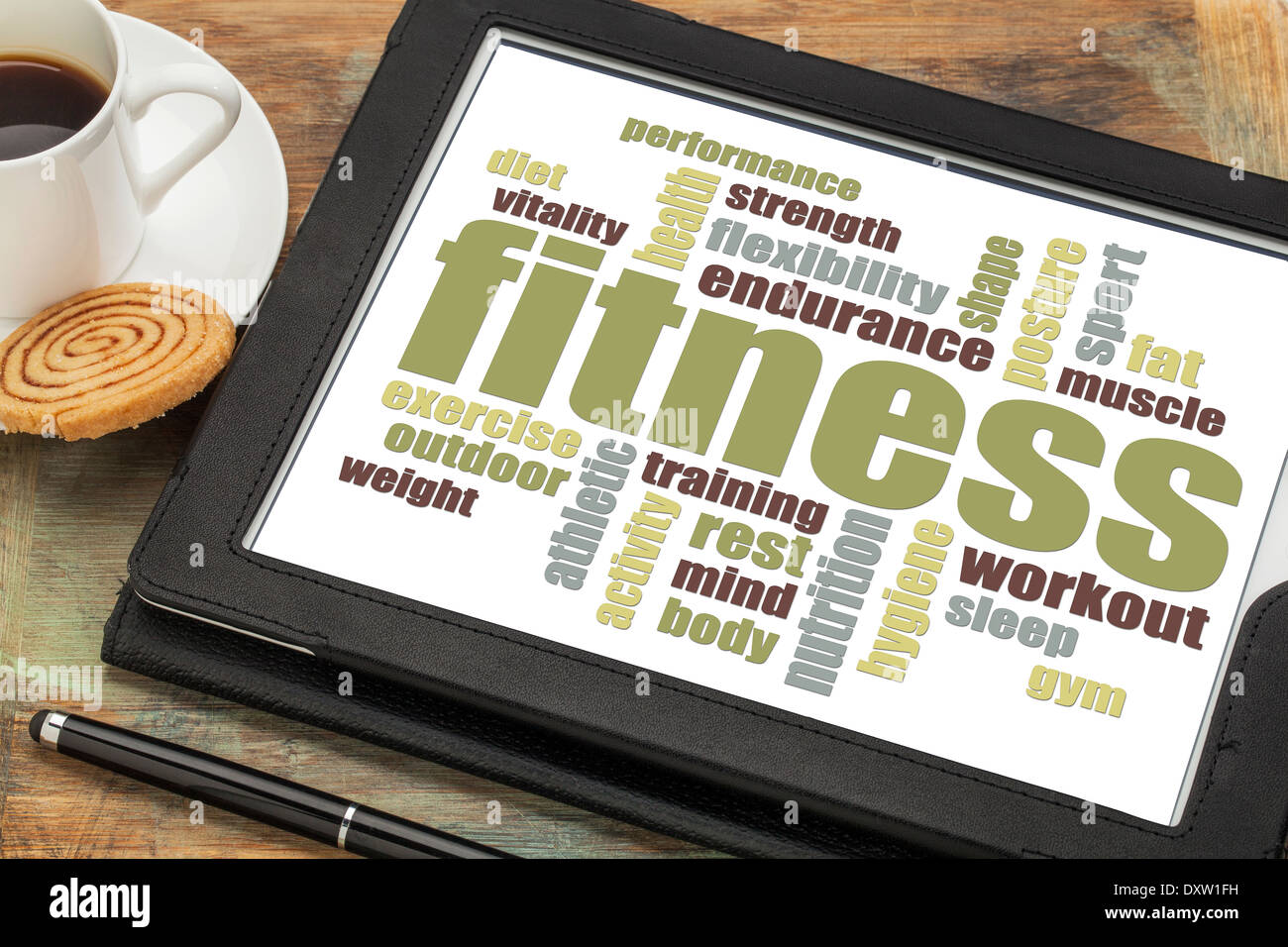 fitness word cloud on a digital tablet with a cup of coffee Stock Photo