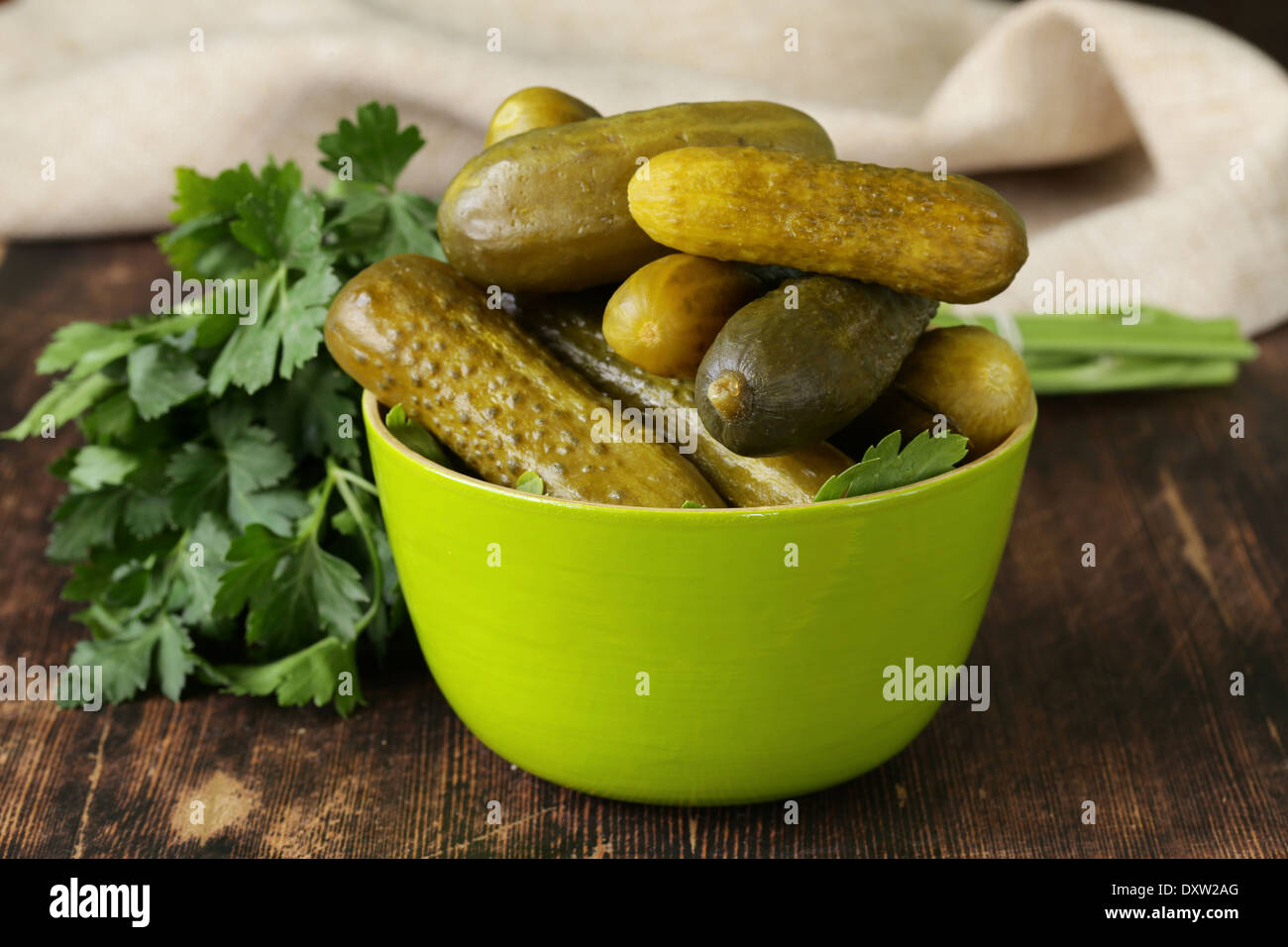 pickled cucumbers in green wooden bowl Stock Photo