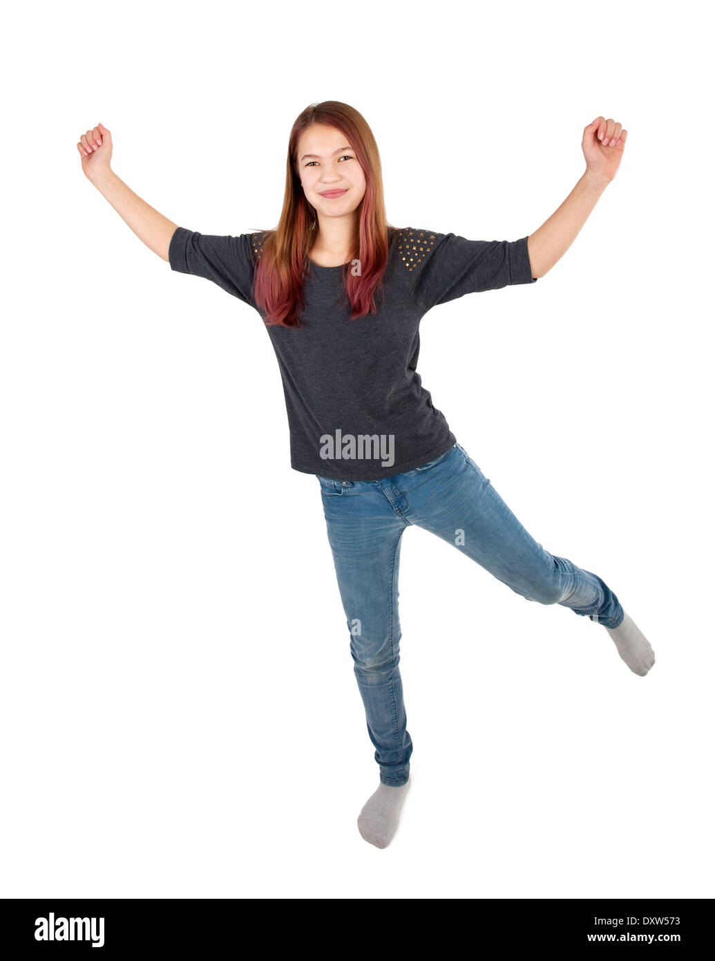 young girl jumping with arms extended Stock Photo