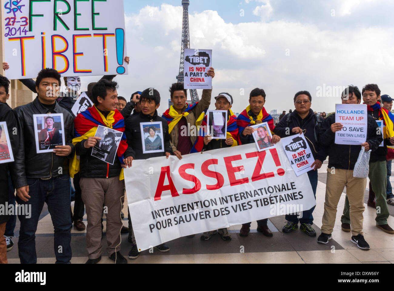 Large Crowd People, Men, The Tibetan, Taiwanese Ethnic Communities of France, and Friends called for French citizens to mobilize during the visit of Chinese President in Paris, Crowd Holding Protest Signs 'Free Tibet' Enough, protest against china, peaceful protest sign, tibet people, tibetan activists, international Politics Stock Photo