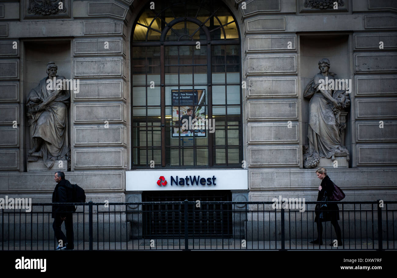 2 people walking past Nat West bank Stock Photo