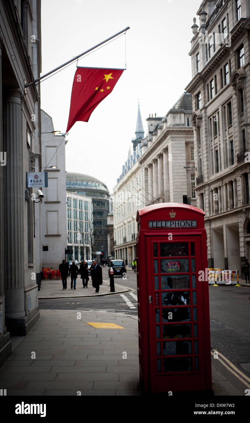 Red phone box with Chinese Red flag in background Stock Photo