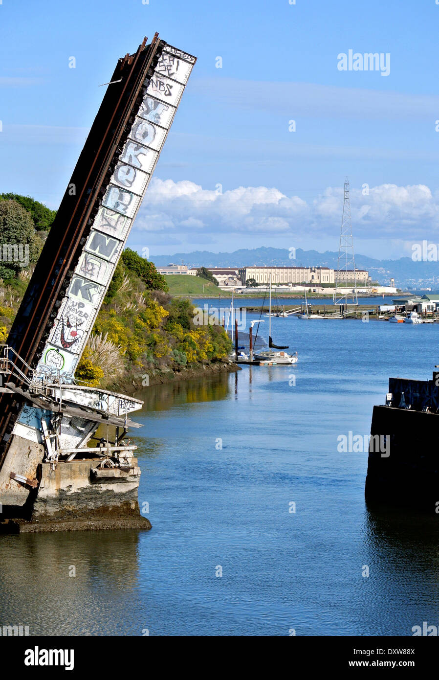 marsh drawbridge over Corte Madera creek with San Quentin in the