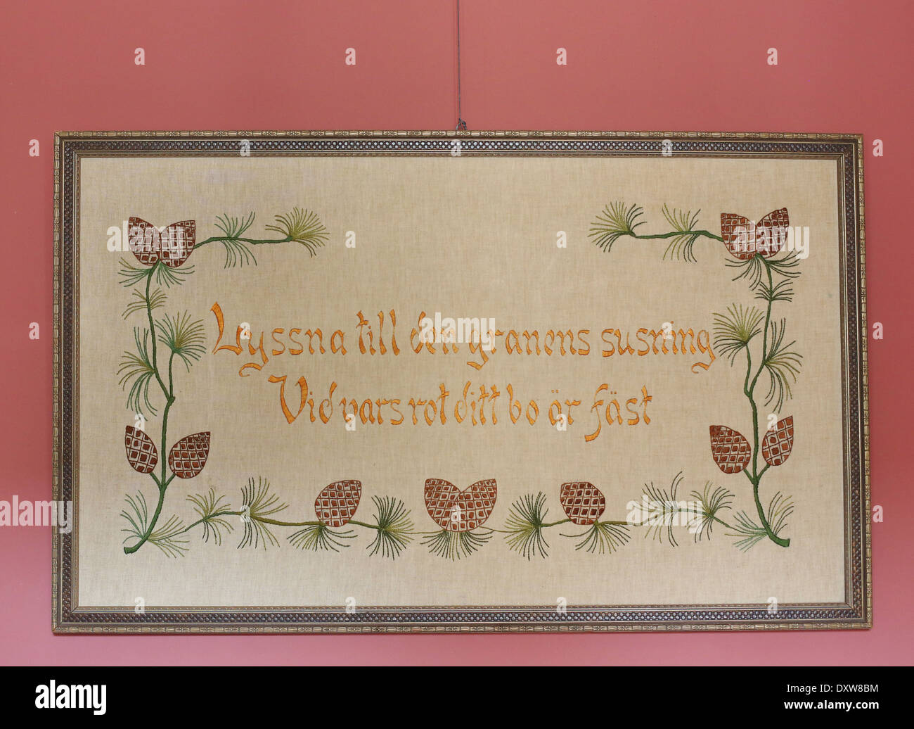 A framed antique handstitched Swedish sampler, hanging on a wall at the Turnblad mansion at the American Swedish Institute. Stock Photo