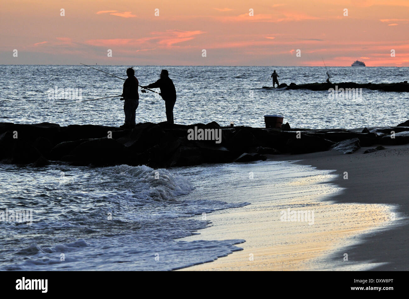 https://c8.alamy.com/comp/DXW8PT/men-fishing-off-the-beach-at-sunset-in-cape-may-nj-usa-DXW8PT.jpg