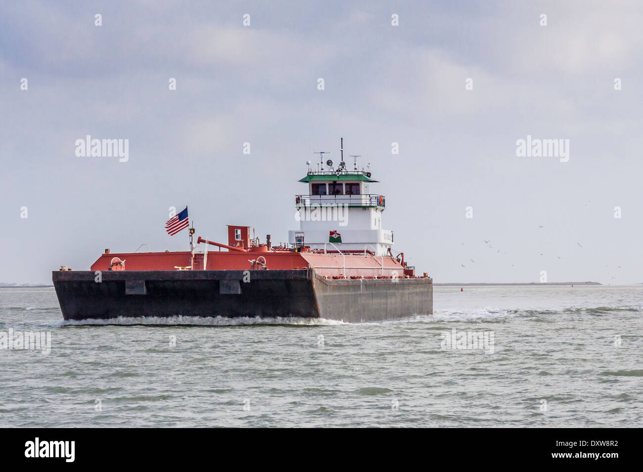 Tugboat and Barge in coastal waterway near Aransas Park National Wildlife Refuge in Southern Texas. Stock Photo