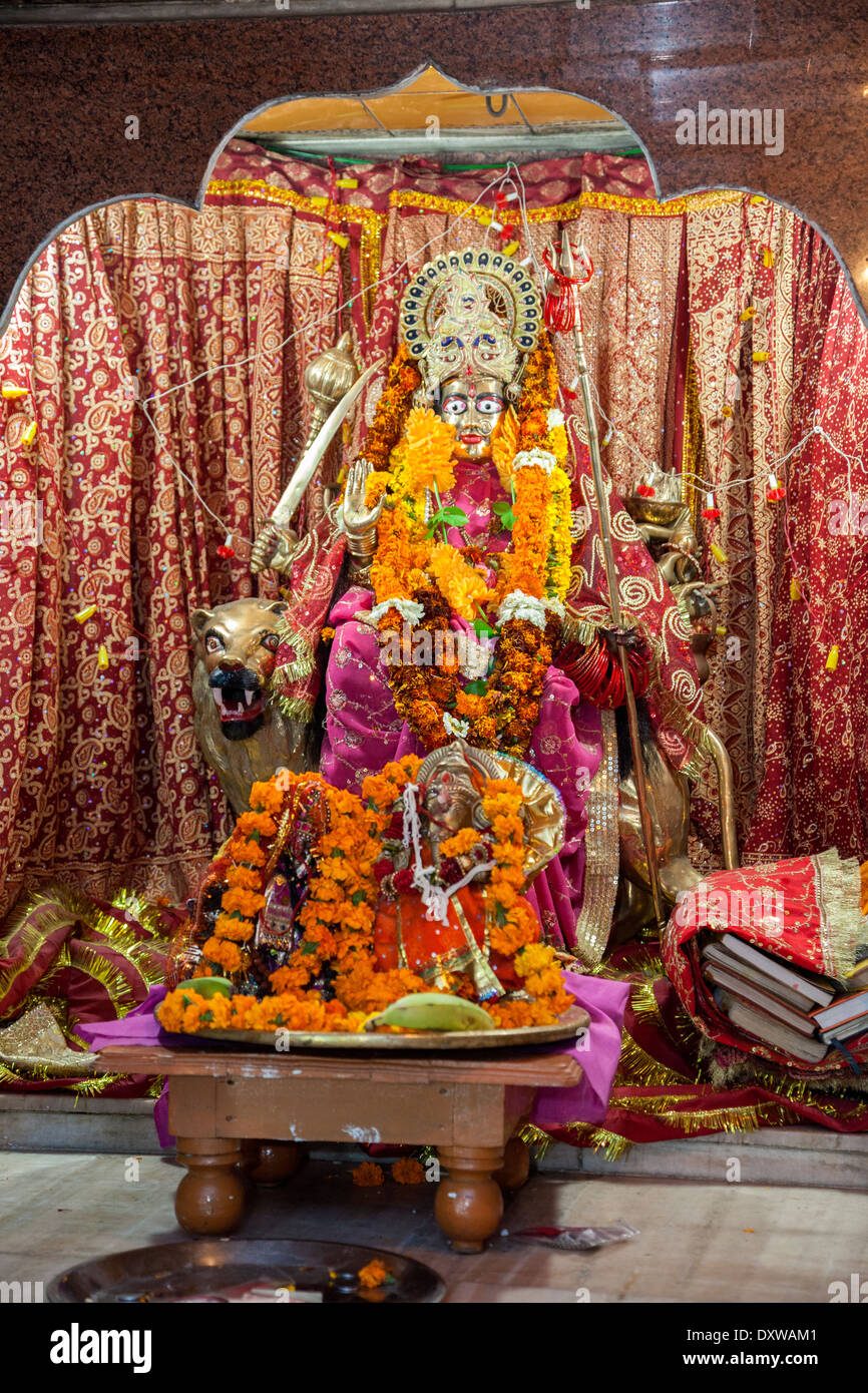India, Dehradun. Shrine to the Goddess Maa Durga, Riding a Tiger, Armed to Destroy Demons. Tapkeshwar Hindu Temple. Stock Photo