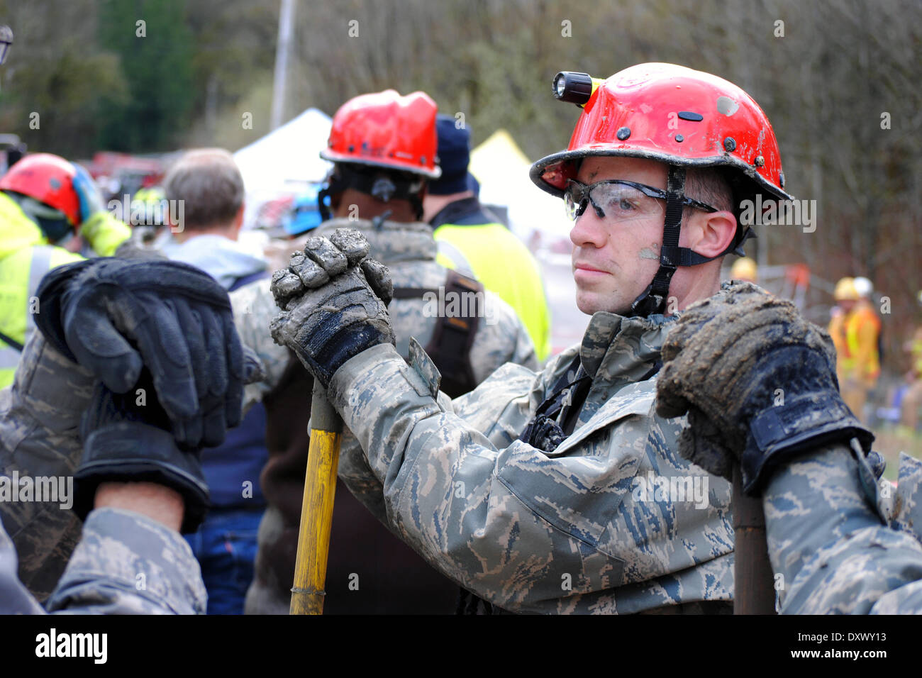 Rescue workers continue efforts to locate victims of a massive landslide that killed at least 28 people and destroyed a small riverside village in northwestern Washington state March 27, 2014 in Oso, Washington. Stock Photo