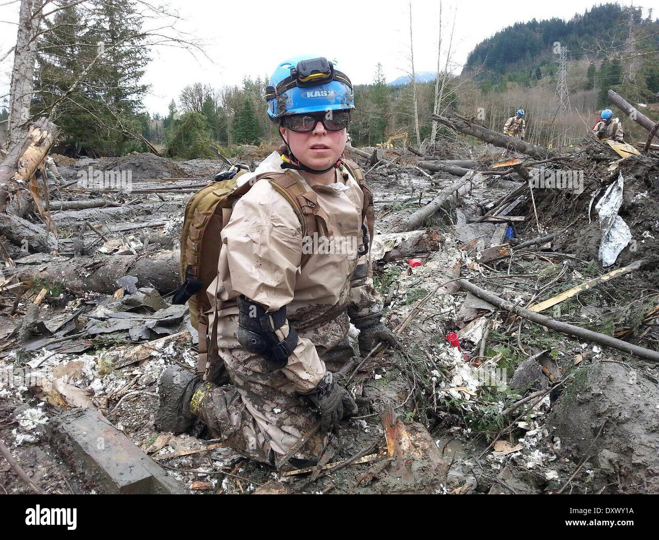 A rescue worker continue efforts to locate victims of a massive landslide that killed at least 28 people and destroyed a small riverside village in northwestern Washington state March 31, 2014 in Oso, Washington. Stock Photo