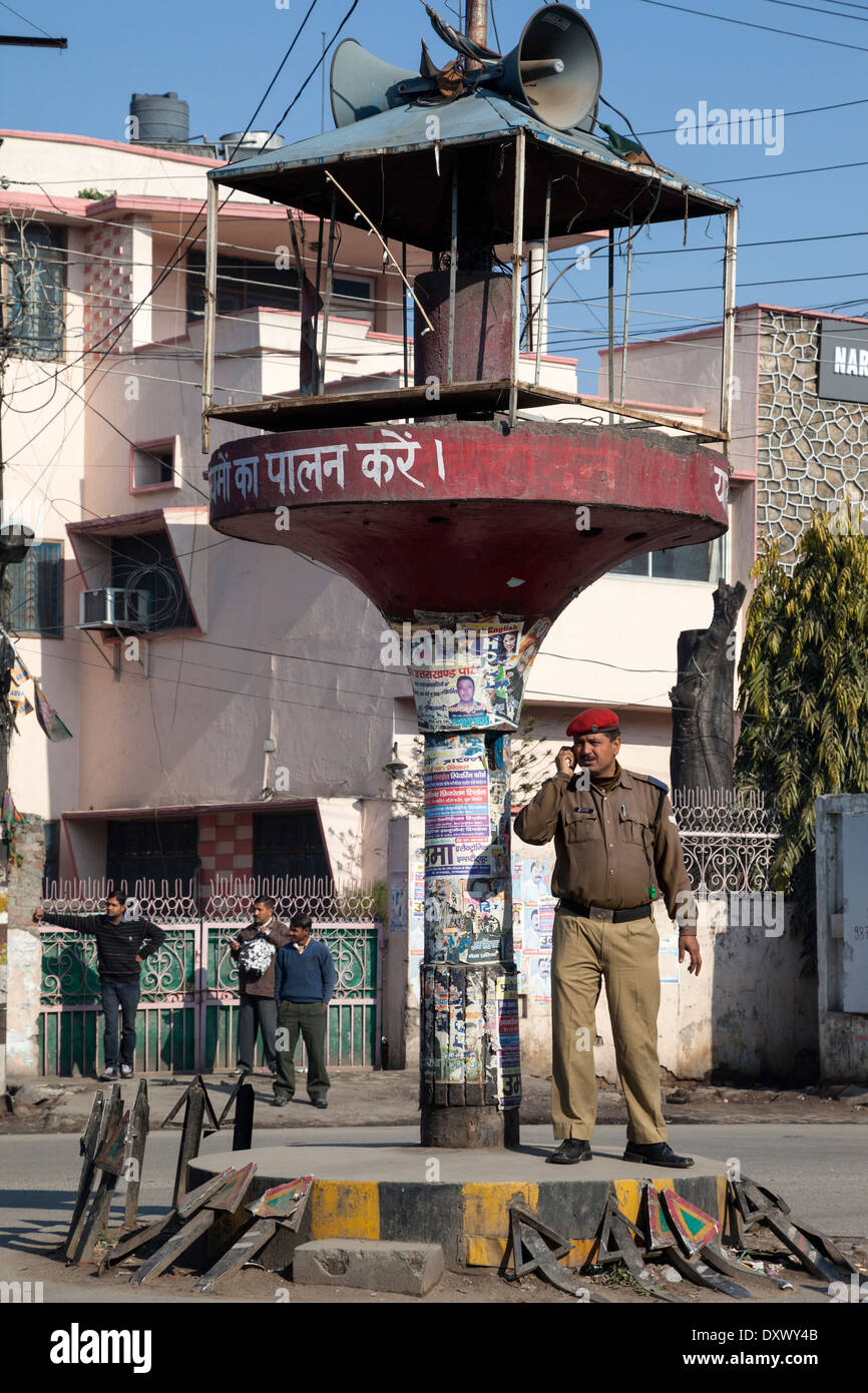 India, Dehradun. Policeman at Traffic Intersection using his Cell Phone. Stock Photo