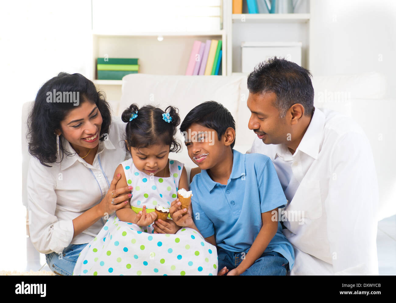 happy indian family enjoying eating ice cream indoor Stock Photo