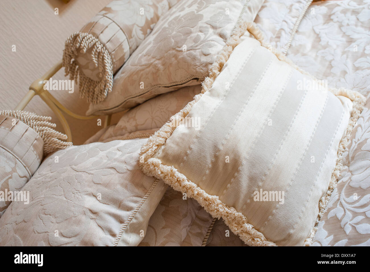 Cushions and pillows arranged on a bed. Stock Photo